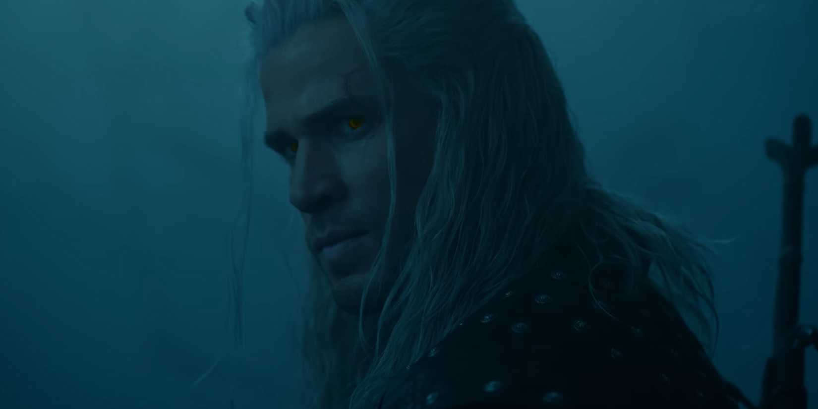 A man with long white hair looking over his shoulder.